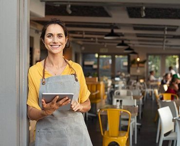 bigstock-Portrait-of-happy-woman-standi-336618316